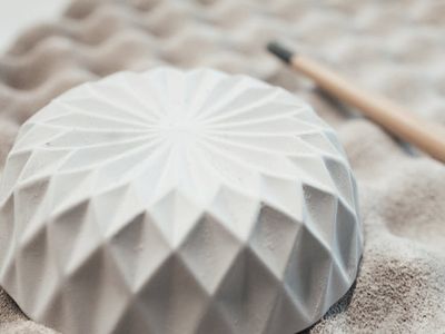 Simple ceramic bowl on a light gray table surface.